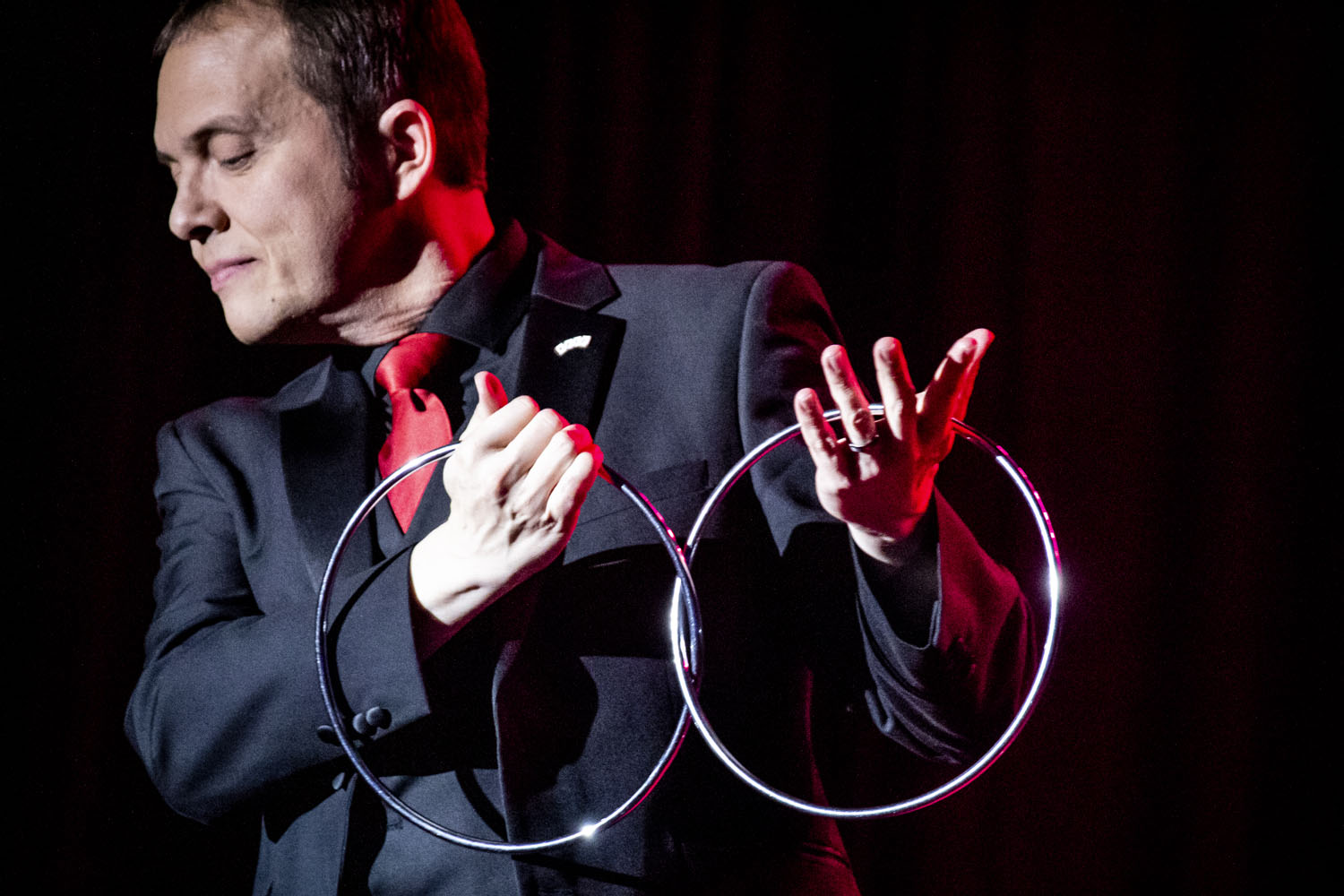 The French magician Boris Wild on stage performing the famous trick of the linking rings